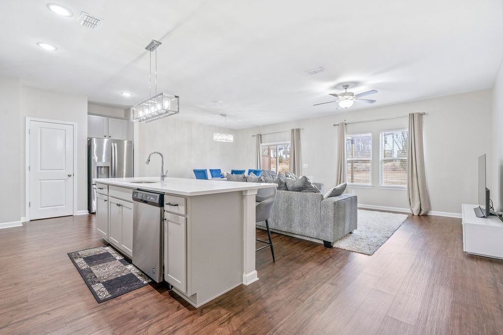 Open floor plan kitchen and living area with quartz island
