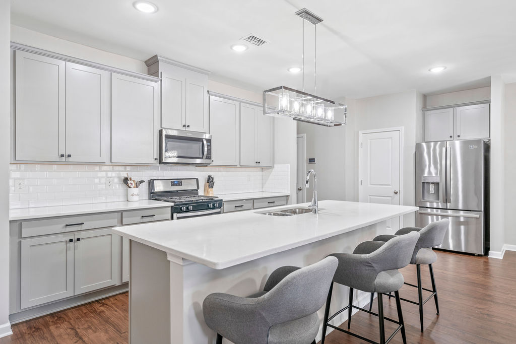 Gourmet kitchen with stainless steel appliances and center island seating