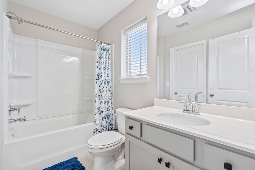 Clean modern bathroom with tub shower combo