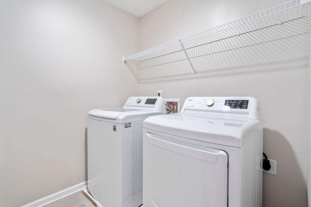Full-size LG washer and dryer in laundry room