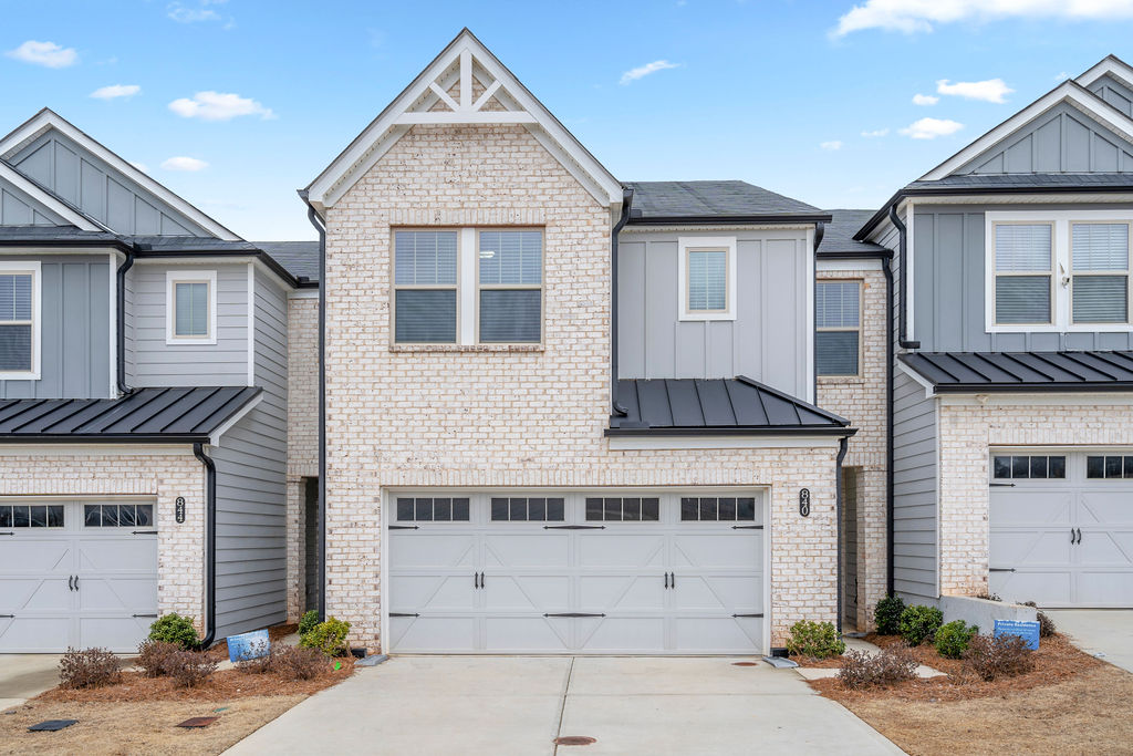 Modern 3-bedroom townhouse exterior with brick facade and two-car garage at 840 Ironhorse Lane Mableton GA